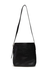 Black textured leather andie 2 in 1 bucket crossbody with slender adjustable strap showcasing main bag features