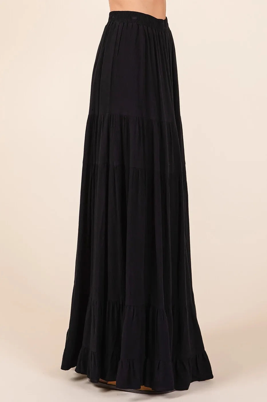 Black tiered flowy elastic waist lined maxi skirt with ruffled hem and flowing fabric for elegant wear