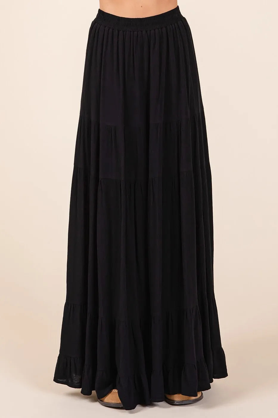 Black tiered flowy elastic waist lined maxi skirt with lightweight fabric and ruffled hem for elegant wear