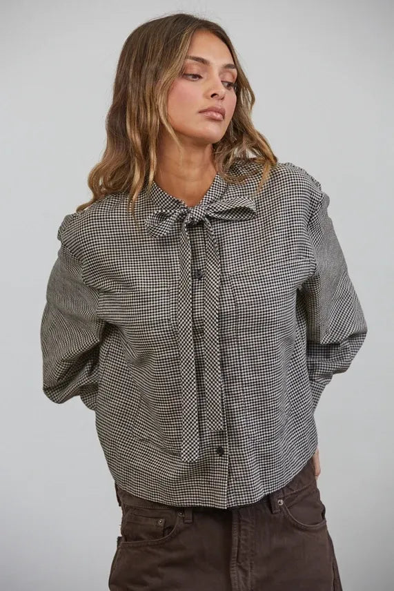 Black and white plaid bow tied collar shirt with button-up front and tied collar detail in soft fabric