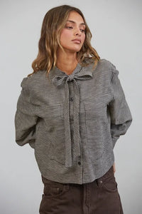 Black and white plaid bow tied collar shirt with button-up front and tied collar detail in soft fabric