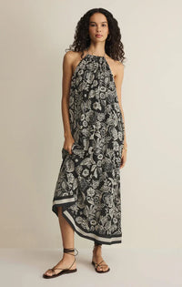 A flowing black and white viento luz floral midi dress with halter neckline and high low hemline