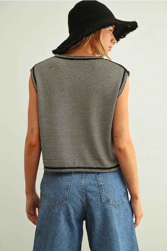 Black and white pinstriped sleeveless knit top with frayed edges featuring a sleeveless knit design