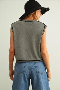 Black and white pinstriped sleeveless knit top with frayed edges featuring a sleeveless knit design