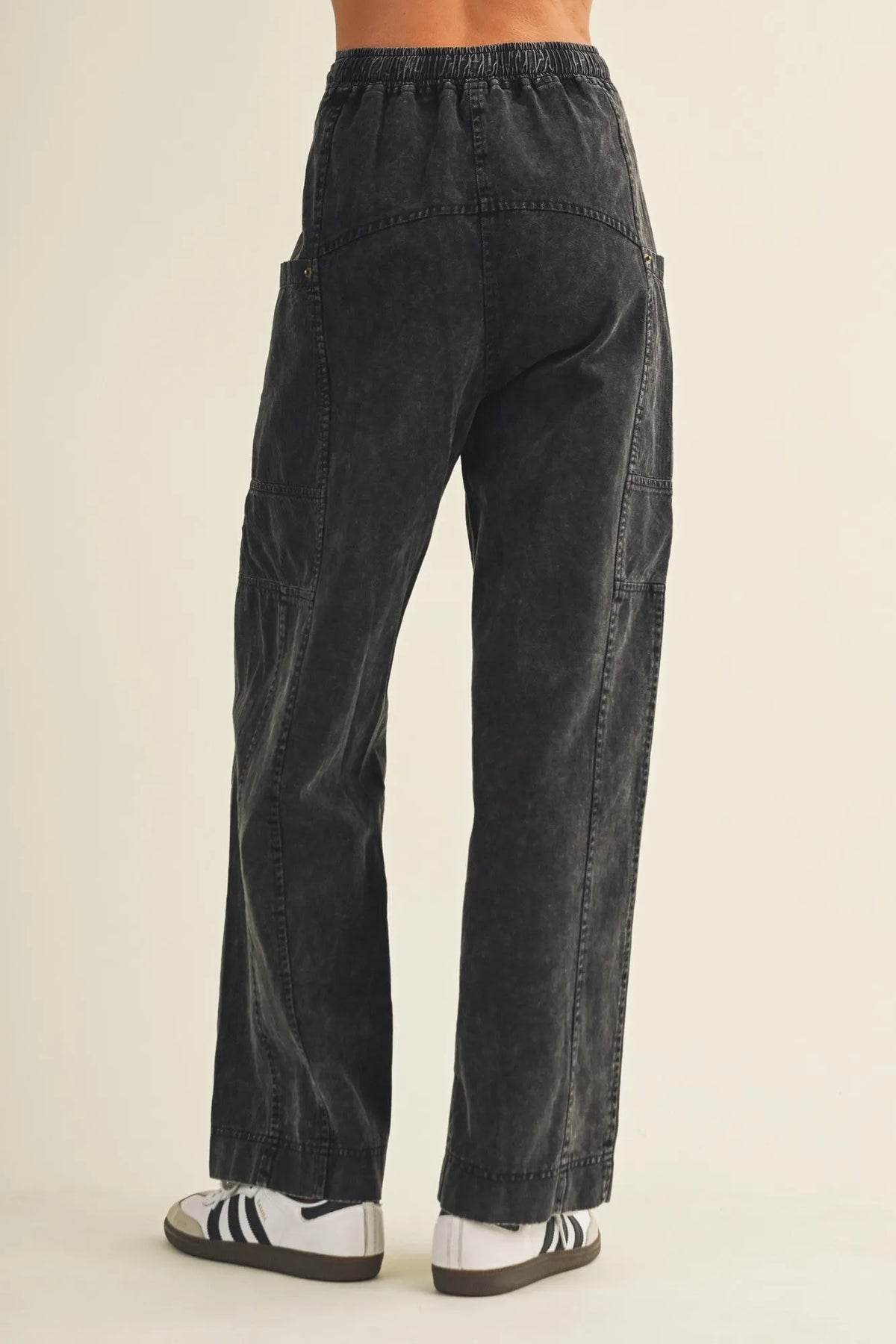 Black drawstring waist wide leg utility pants with relaxed fit cargo pockets and elastic waistband