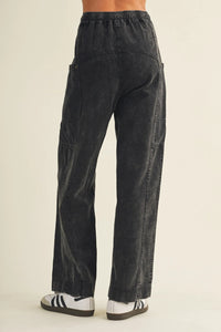 Black drawstring waist wide leg utility pants with relaxed fit cargo pockets and elastic waistband