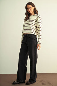 Black low rise baggy wide leg denim jeans with a straight fit and classic stitching details for casual wear