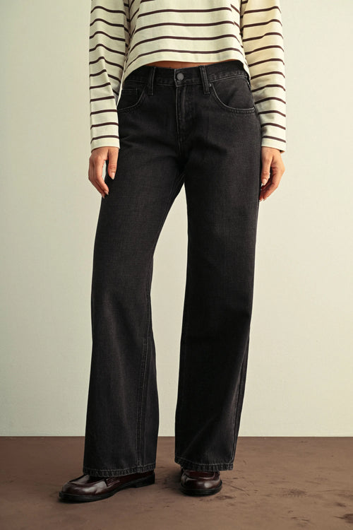 Black low rise baggy wide leg denim jeans featuring a straight-cut silhouette and classic five-pocket design