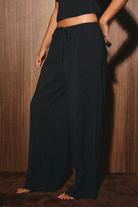 Black low rise wide leg drawstring pants featuring a comfortable waistband and relaxed fit for casual wear