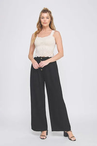 Black wide-leg trousers with button-front design paired with lovely scallop edge bralette tank for stylish layering