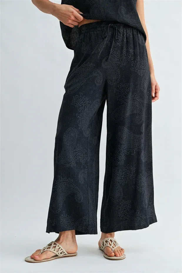 Black paisley printed elastic waist pants with subtle gray wide-leg pattern and comfortable fit