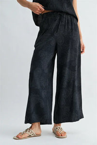 Black paisley printed elastic waist pants with subtle gray wide-leg pattern and comfortable fit