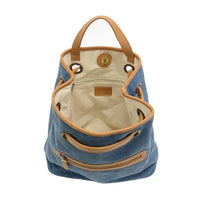 Blue memphis canvas backpack with tan leather handles and trim made of durable canvas material