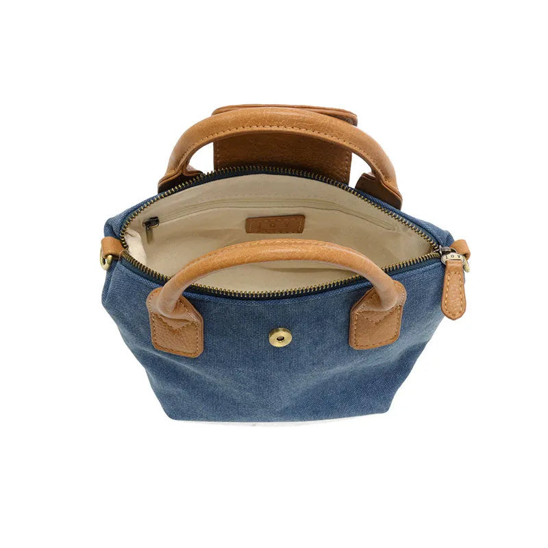 Blue denim abilene canvas mini tote crossbody with tan leather handles and trim for versatile use