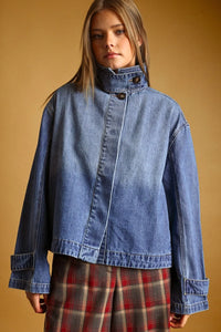 Blue denim jacket with high collar and button closures in a shirts styled denim jacket design