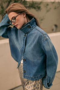 Blue denim jacket with high collar and button closures in shirts styled denim jacket design