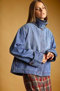 Blue denim jacket with high collar and button closures in a shirts styled denim jacket design