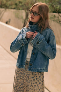 Blue denim jacket with high collar and button closures in shirts styled denim jacket design