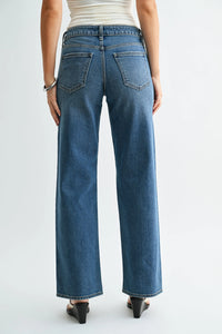 Loose low rise stretch straight denim jeans in blue with wide-leg cut and classic back pockets shown from the back side