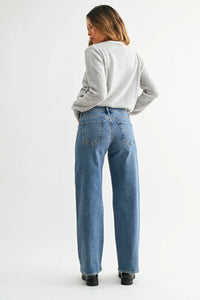 Blue denim mid rise slim wide leg jeans with light stretch shown from the back featuring classic pockets