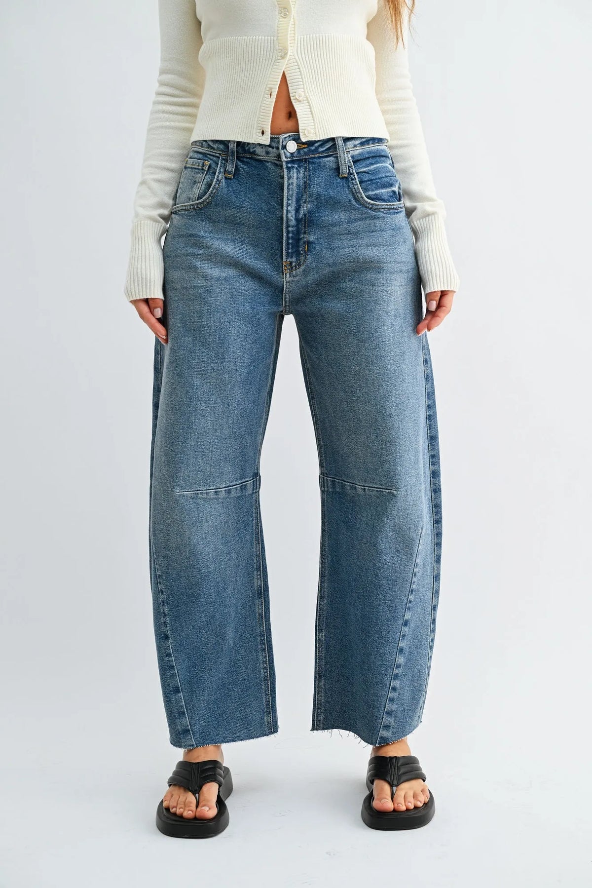 Blue denim jeans with a wide leg denim barrel cut and frayed hems for a stylish casual look