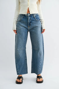 Blue denim jeans with a wide leg denim barrel cut and frayed hems for a stylish casual look