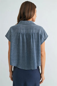 Blue denim dolman sleeve button down shirt with collar and gathered back detail showing back side