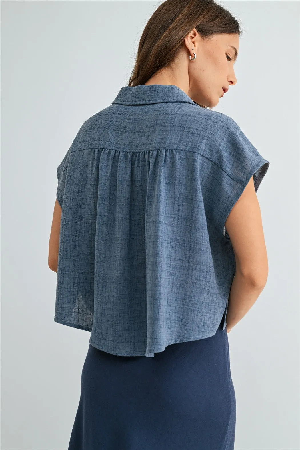 Blue denim dolman sleeve button down shirt with relaxed fit and subtle texture in short sleeves