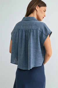 Blue denim dolman sleeve button down shirt with relaxed fit and subtle texture in short sleeves