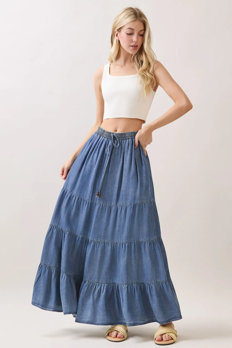 A flowing blue tencel elastic waisted tiered maxi skirt with ruffles and a drawstring waist