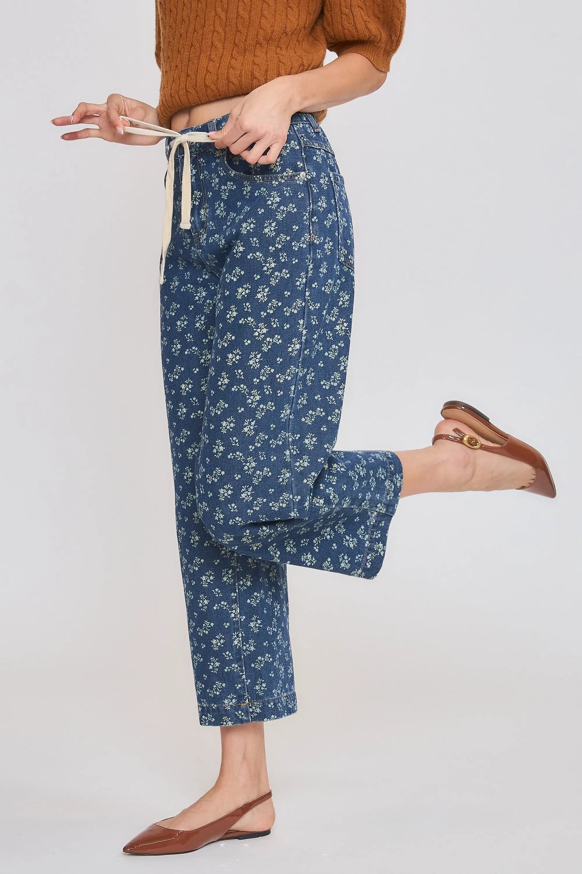 High rise floral straight leg denim jeans in blue with white floral pattern and drawstring waist detail