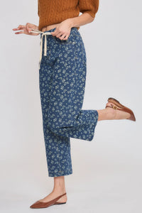 High rise floral straight leg denim jeans in blue with white floral pattern and drawstring waist detail