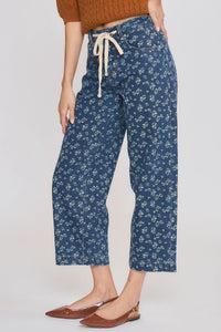 High rise floral straight leg denim jeans in blue with delicate white floral pattern and cream drawstring waistband