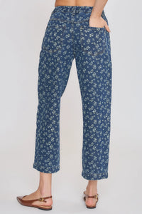 Blue high rise floral straight leg denim jeans with delicate white floral pattern and rolled cuffs