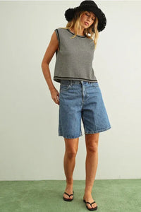 Blue denim shorts with straight-leg cut and frayed hem paired with pinstriped sleeveless knit top