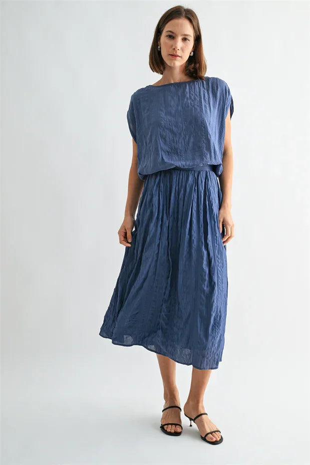 Crinkle satin elastic hem top with flowing blue textured fabric and asymmetrical hem