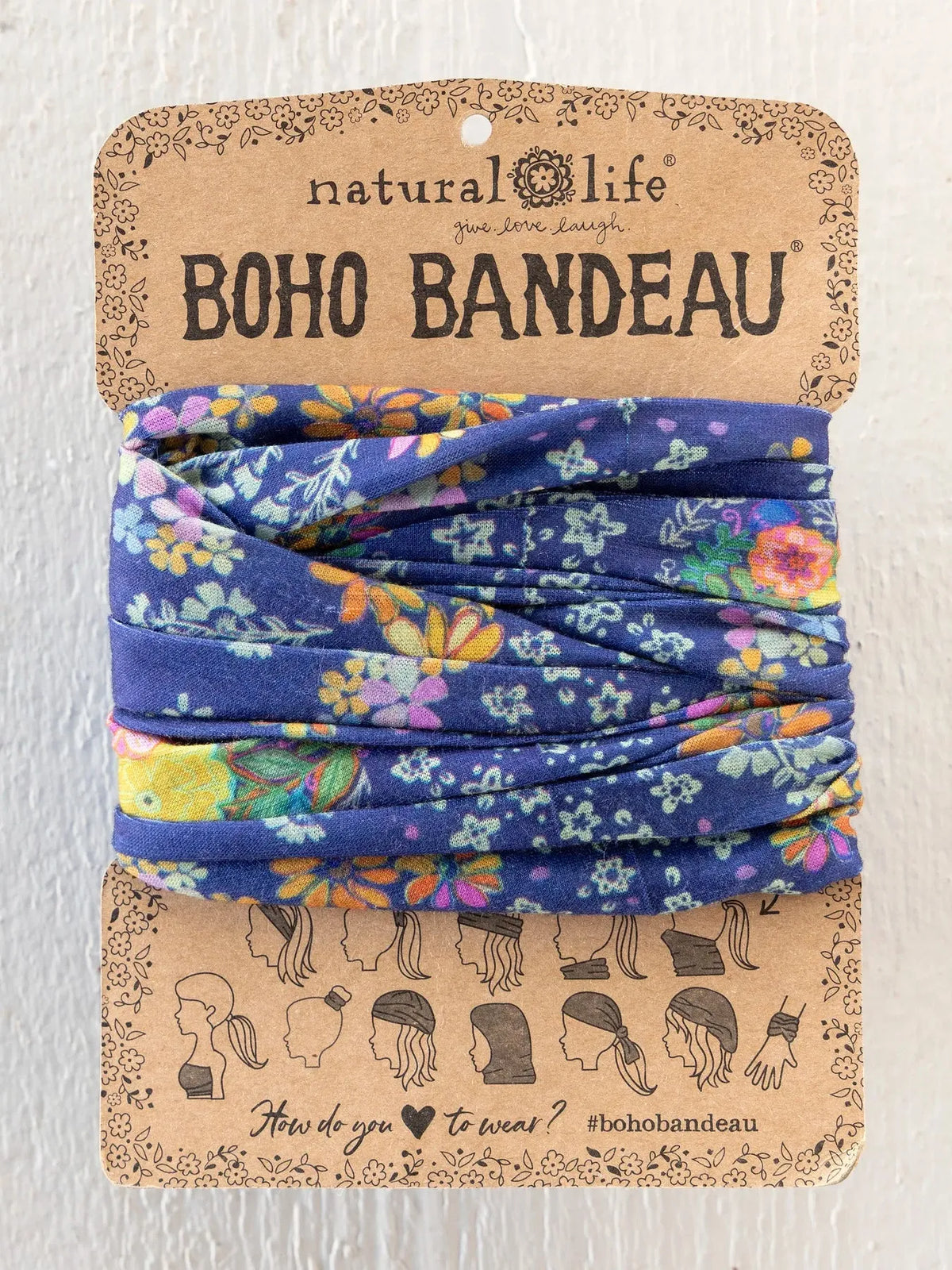 A blue floral-patterned boho bandeau headband made of soft fabric in tropic bandana navy by natural life