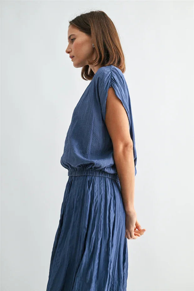 Flowing blue crinkle satin elastic hem top with draped sleeveless design
