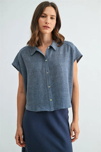 Blue linen dolman sleeve button down shirt with subtle textured weave and light green sleeve buttons