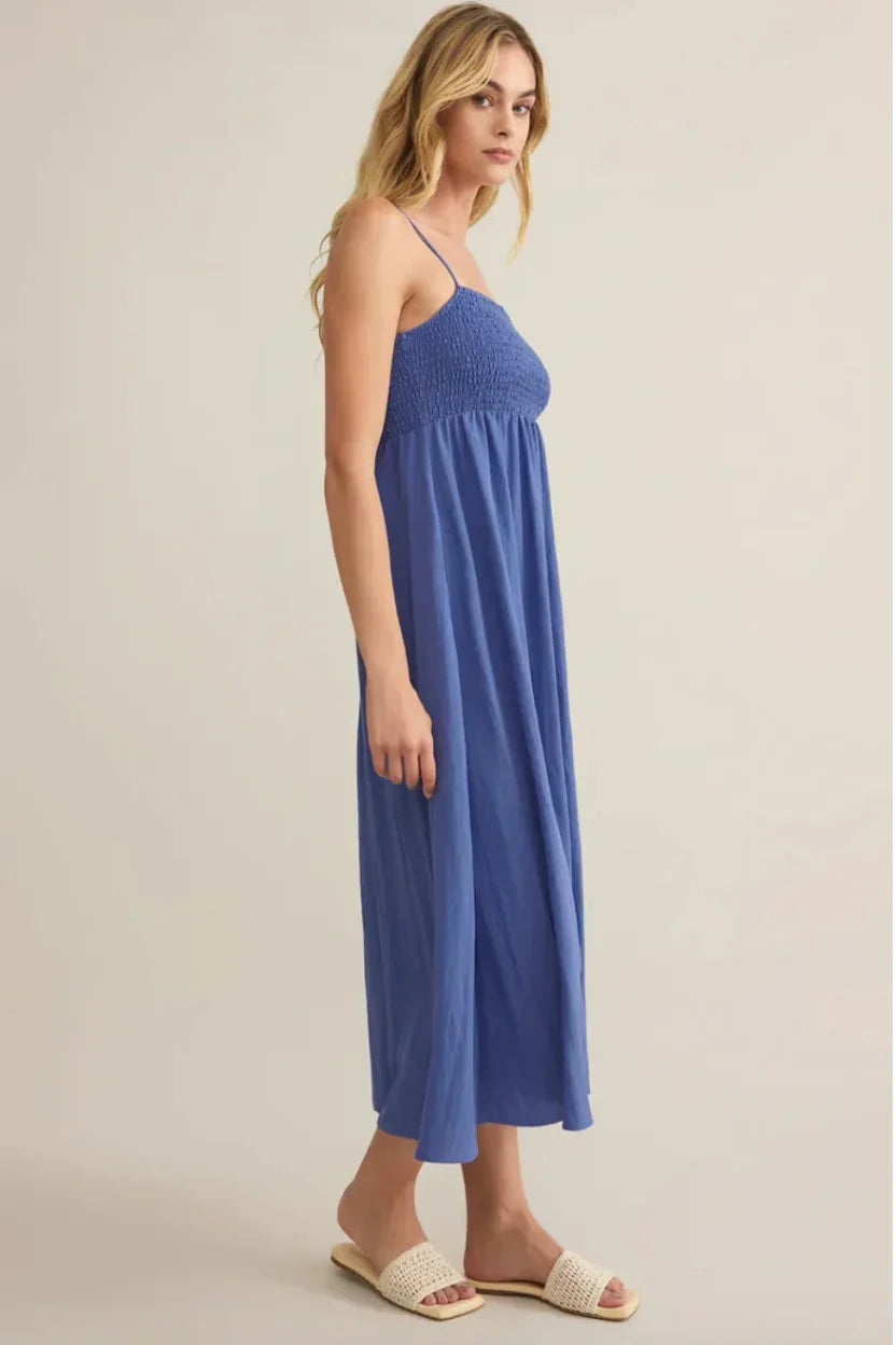 Beachside smocked midi dress with flowing blue fabric and thin straps