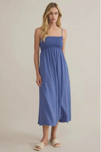 Beachside smocked midi dress with flowing blue fabric and spaghetti straps