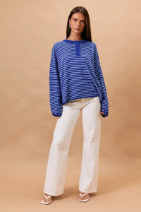 Blue and white striped long sleeve crew neck henley top with buttoned placket for casual wear