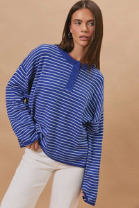 Blue and white striped long sleeve crew neck henley sweater with button closure for casual wear