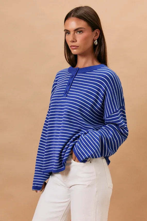 Blue and white striped knit long sleeve crew neck sweater with buttoned neckline for casual wear