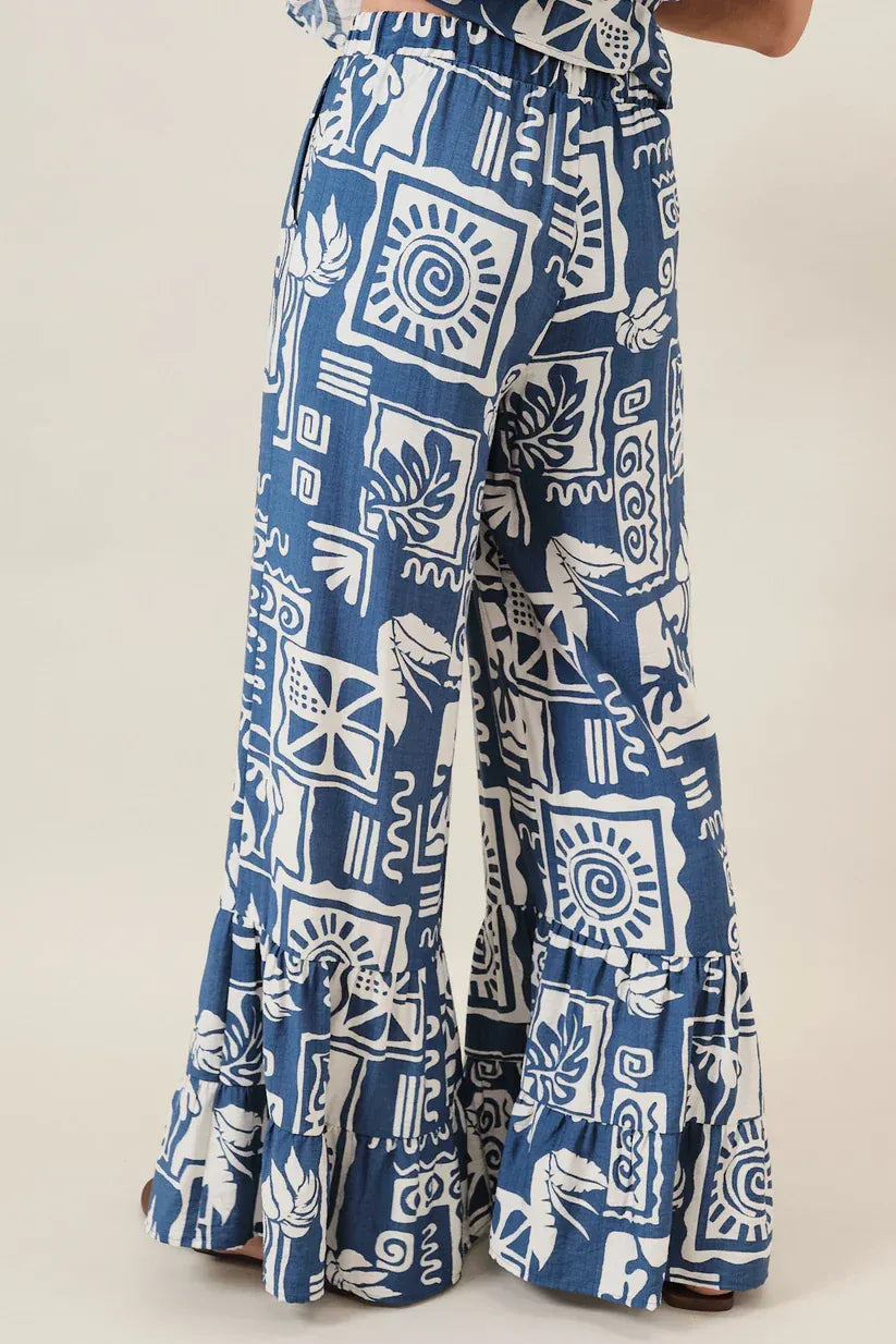 Blue and white abstract printed ruffle pants with wide-leg cut and ruffled hem perfect for women’s boho chic clothing