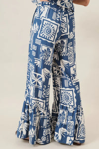 Blue and white abstract printed ruffle pants with wide-leg cut and ruffled hem perfect for women’s boho chic clothing