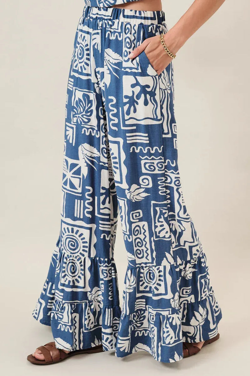 Blue and white abstract printed ruffle pants with wide-leg cut and ruffled hem for women’s boho chic clothing