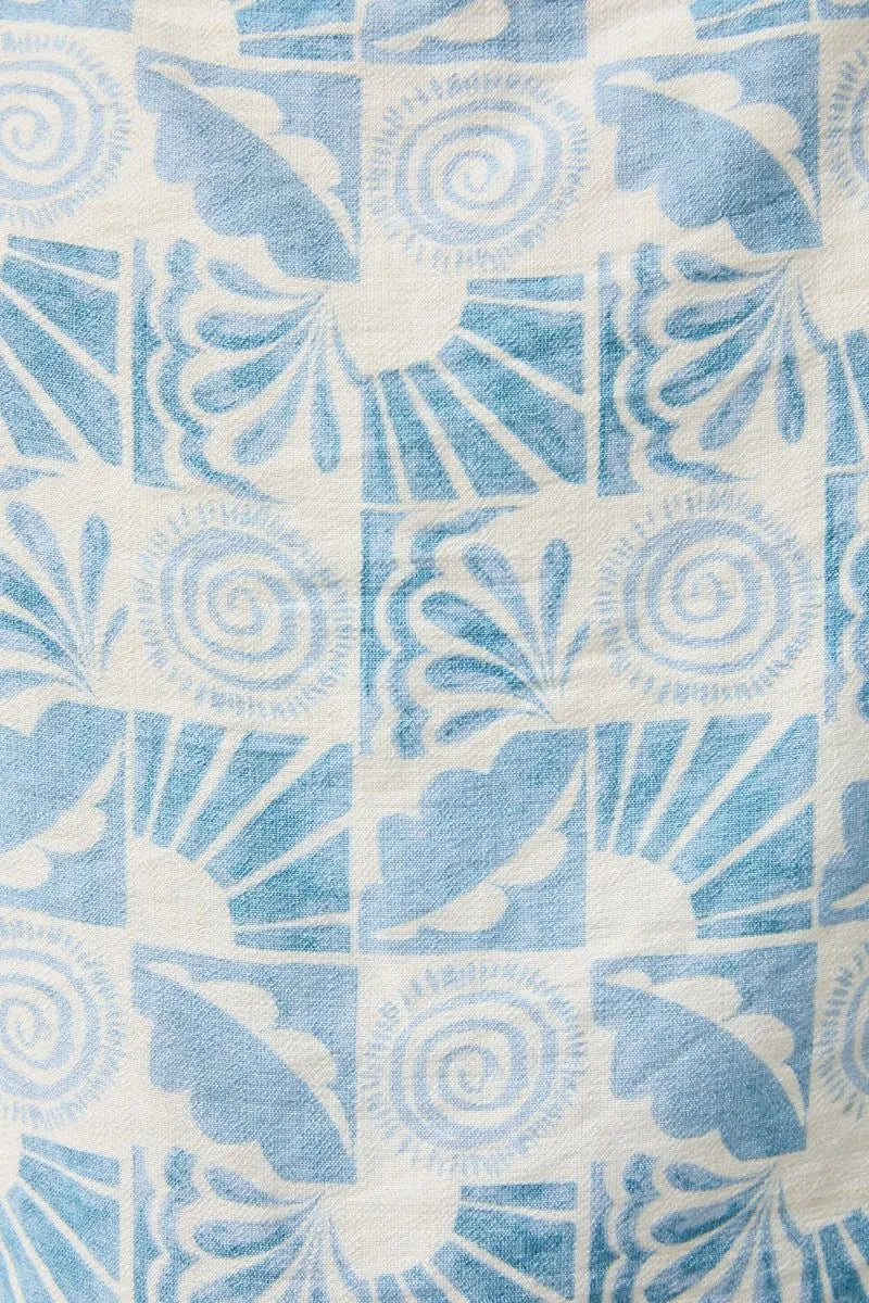 Abstract print elastic waist tie pants featuring blue and white patterned textile with floral and spiral motifs