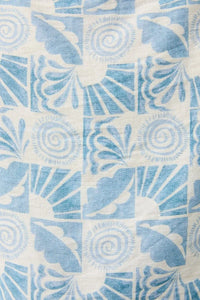 Abstract print elastic waist tie pants featuring blue and white patterned textile with floral and spiral motifs