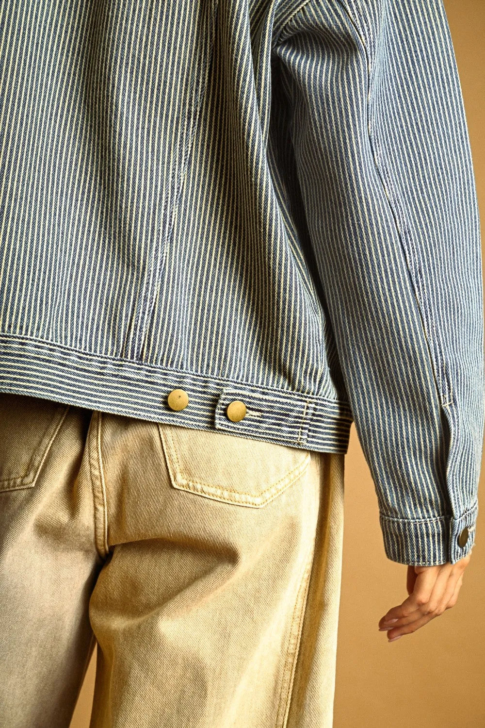 A blue and white striped pattern denim jacket with brass buttons showcasing a classic pattern denim jacket design